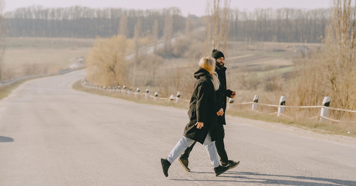 Seasoning a wok in the wrong way? - Young couple crossing road in wrong place at countryside