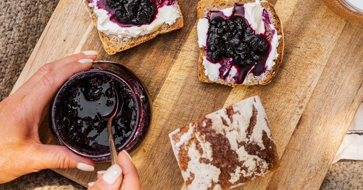 Seedless blueberry jam - consistency - Person Holding Brown Wooden Stick With Chocolate Cake