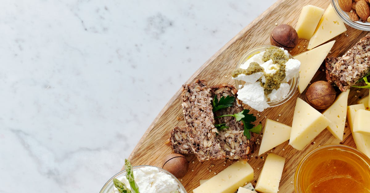 Seeking a creamy/melty Swiss Cheese commonly available in the US - Close-Up Photo Of Sliced Cheese On Brown Wooden Chopping Board