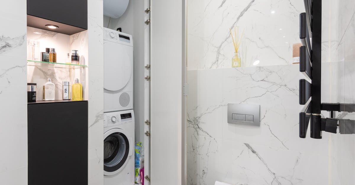 self clean while door open [closed] - Bathroom interior with washing machine against toilet bowl