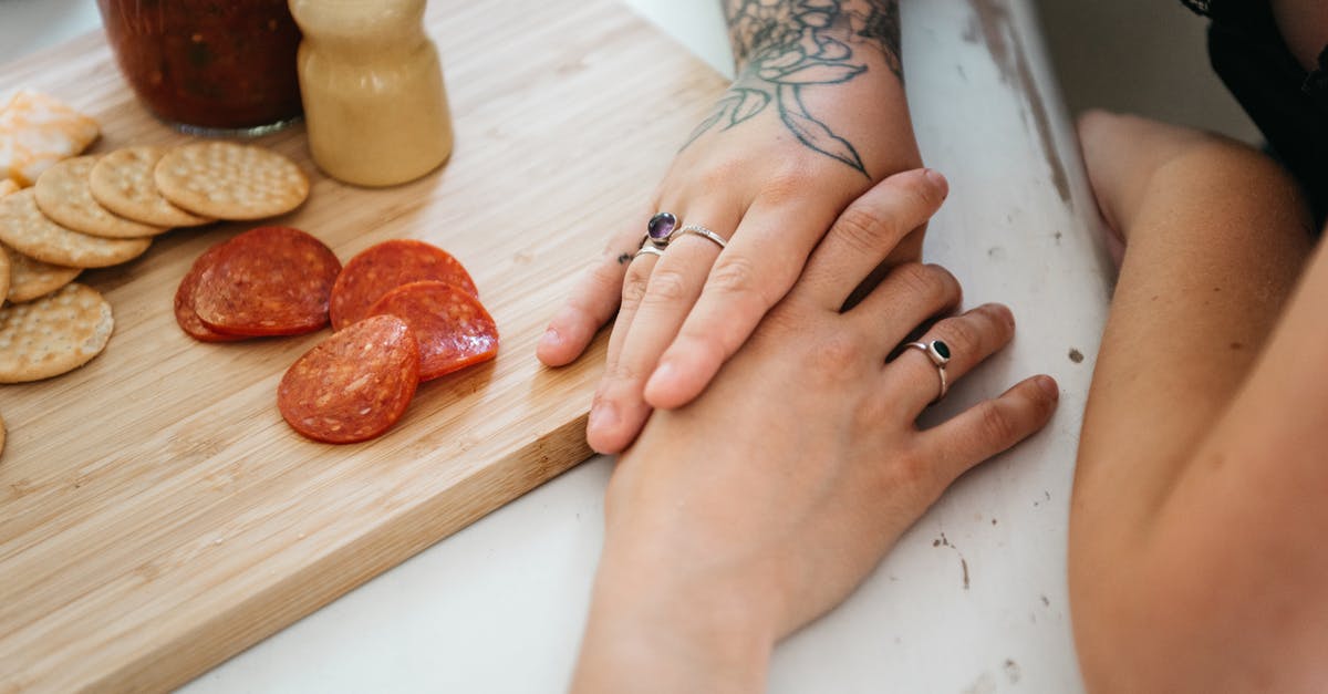 Separating chocolate-coated cookies stuck together - A Sweet Couple Touching Hands While Having Breakfast