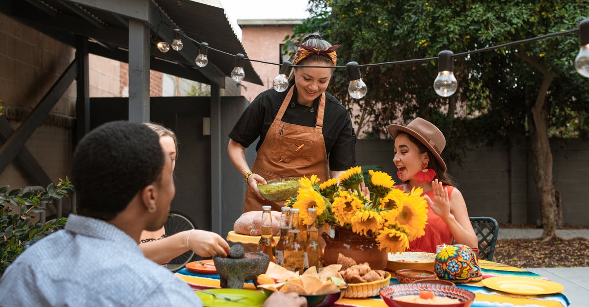 Serving Creme Brulee to a large group of people - Group of Friends Eating Mexican Food