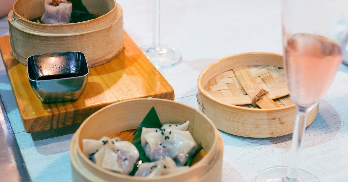 Sesame soy vinegarette - Delicious traditional Asian dim sum dishes in wooden bowls served on table