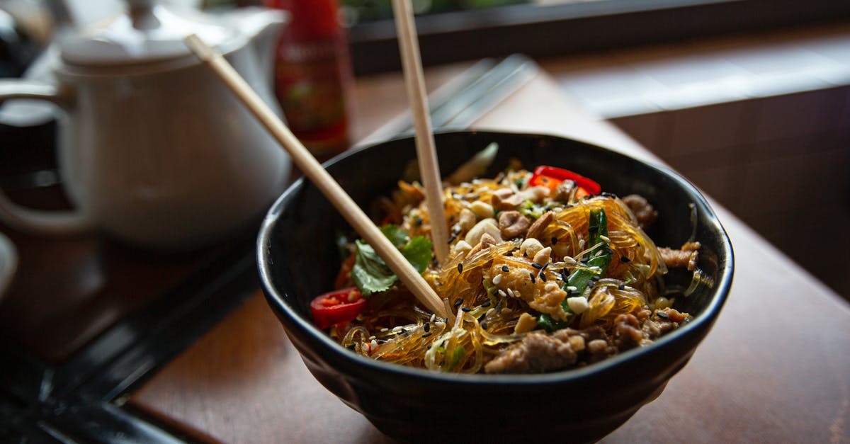 Sesame soy vinegarette - Bowl of delicious noodles with meat and vegetables served on table