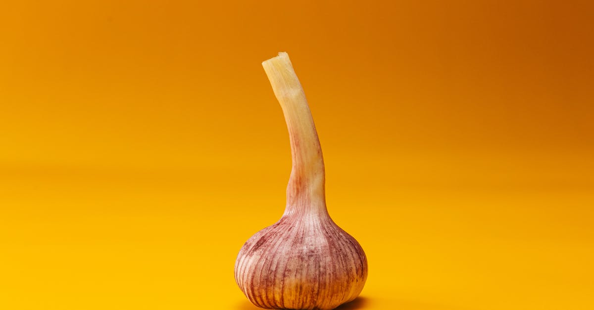 Shaking Method for Garlic - Brown Wooden Spoon on Yellow Surface