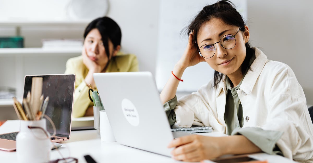 Shaping baguettes using three folds vs. rolling it up? - Woman Wearing Round Eyeglasses Using a Laptop