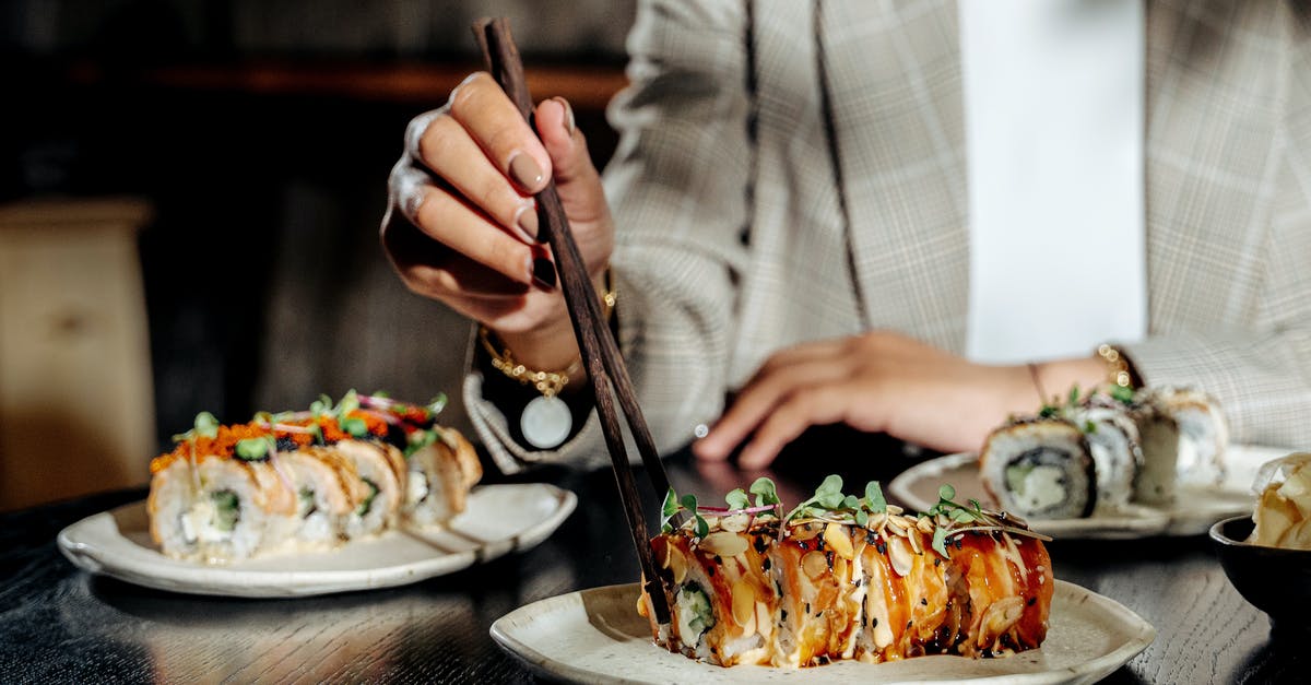 Shaping baguettes using three folds vs. rolling it up? - A Woman Using Wooden Chopsticks on Sushi Rolls