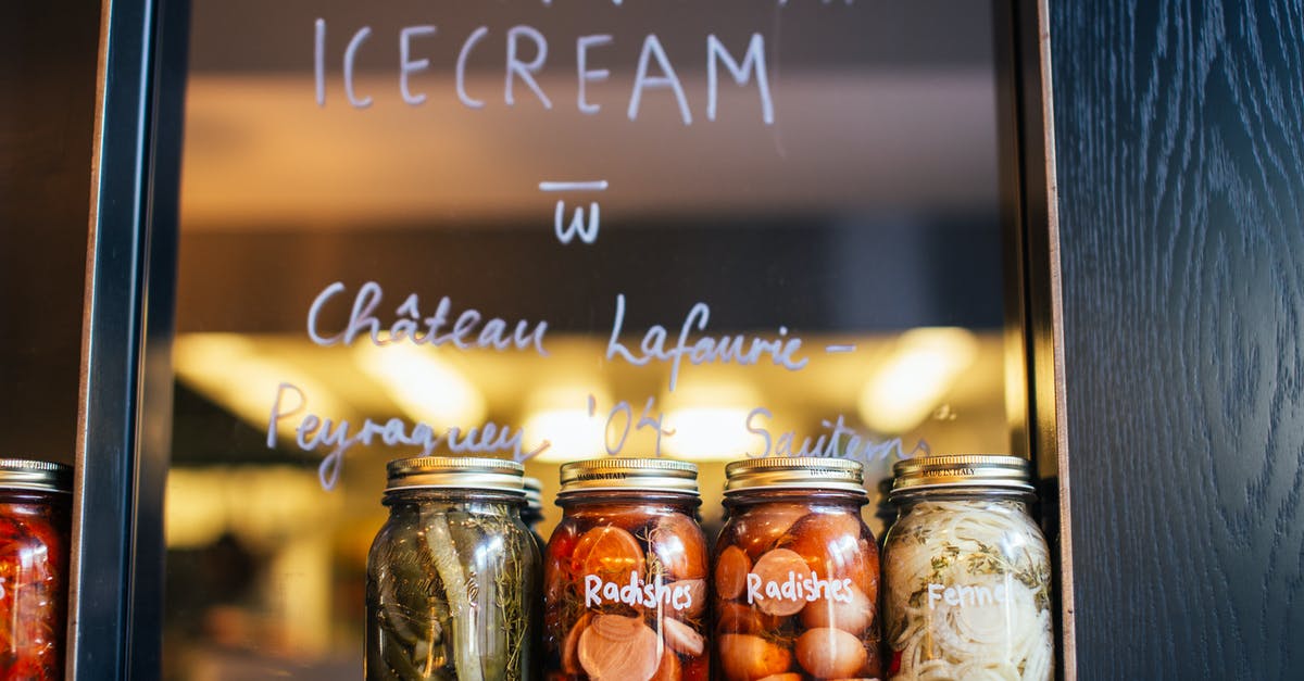 Shelf stability of uncanned vinegar-pickled vegetables - Jars with various pickled vegetables on shelf in cafe