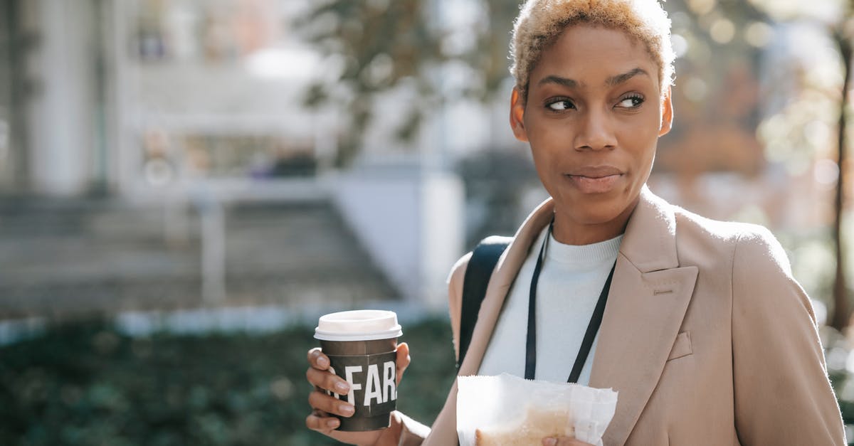 Short-term bread storage - Positive black businesswoman with coffee and sandwich