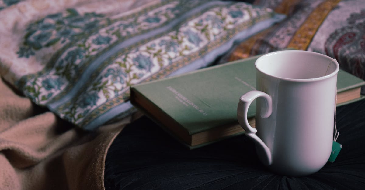 Should a [Ceramic] mug be left covered or uncovered during the tea bag steeping process? - Mug and book placed on table