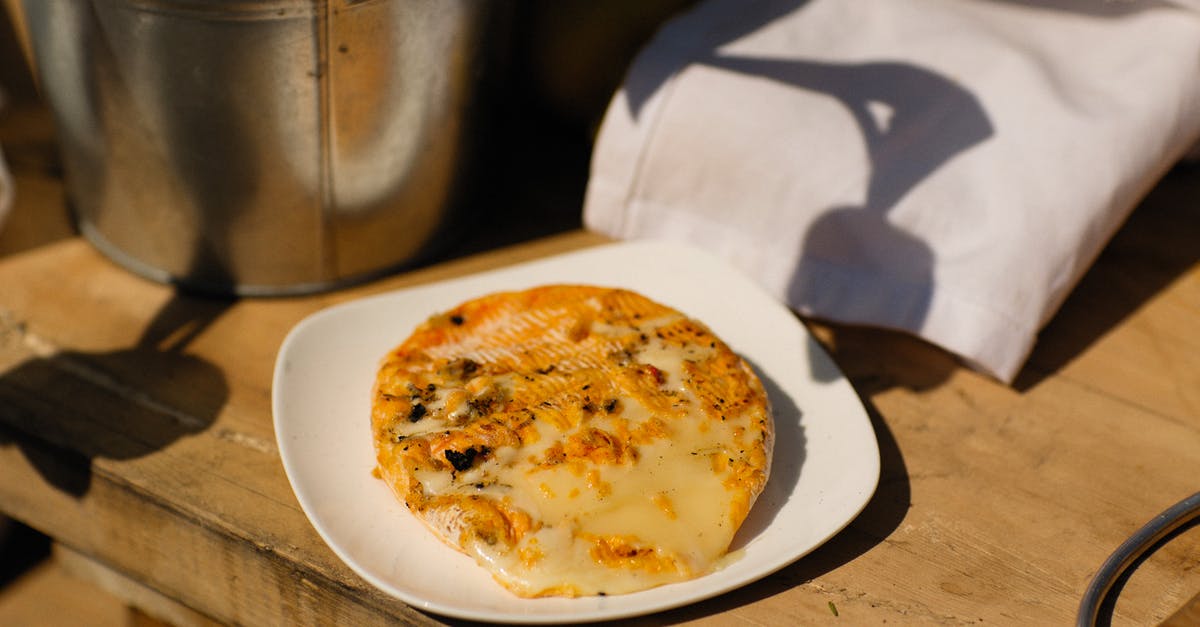 Should cheese be frozen? - Brown and White Round Pizza on White Ceramic Plate