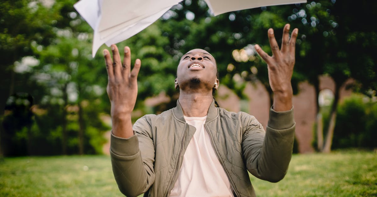 Should enriched doughs pass the windowpane test? - Content black remote worker throwing work papers in air happy to get rid of boring paperwork while sitting in green park with laptop