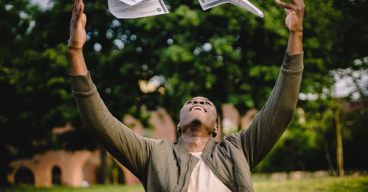 Should enriched doughs pass the windowpane test? - Happy African American remote worker tossing papers in air happy to get rid of boring paperwork while sitting in green park