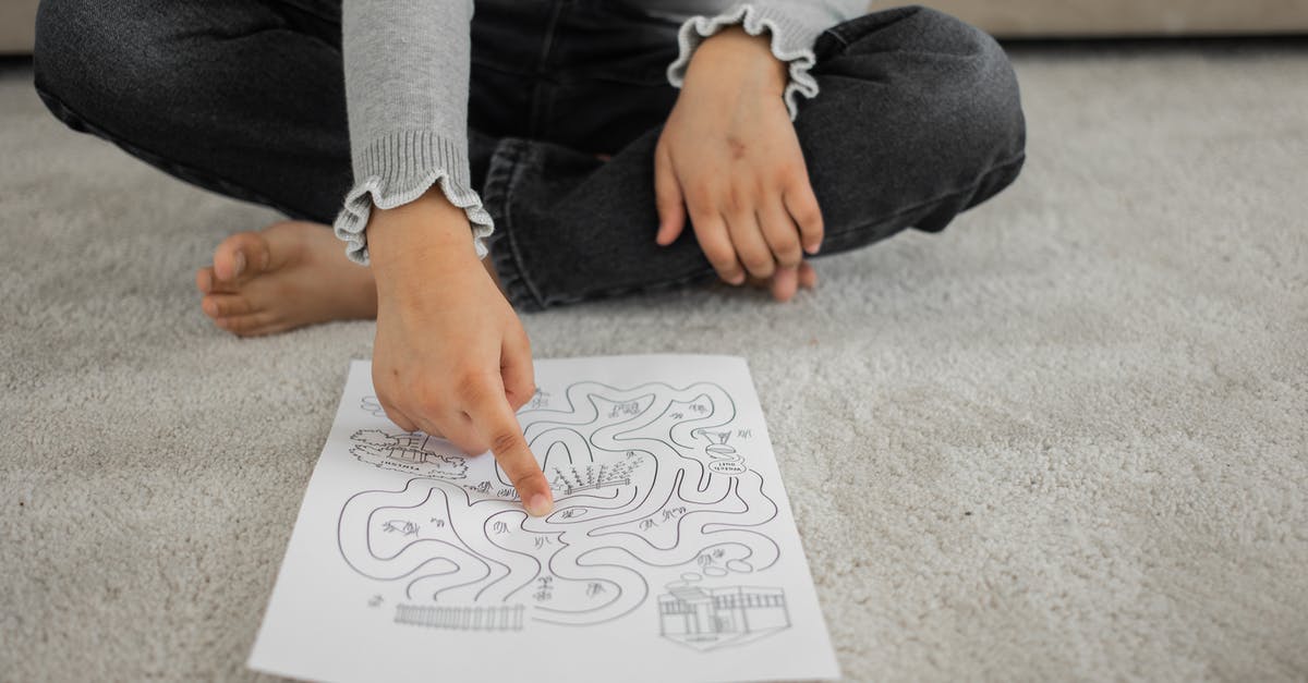 Should enriched doughs pass the windowpane test? - Crop anonymous barefooted child sitting on floor with crossed legs and solving labyrinth puzzle at home