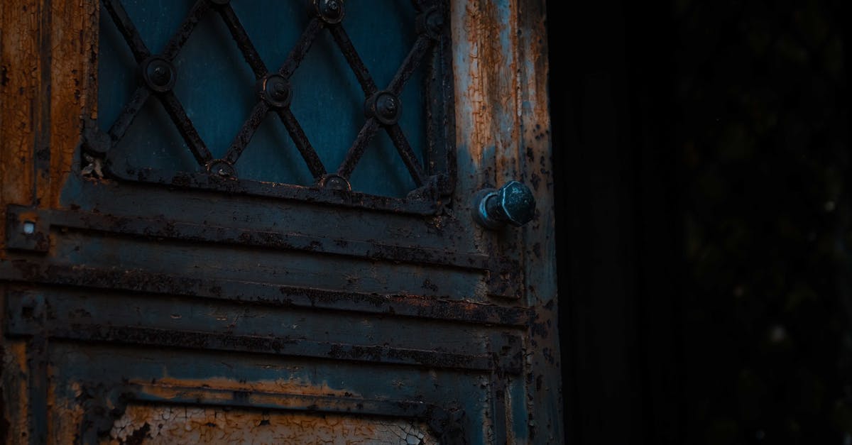 Should flour be thrown out past its expiry date? - Low angle of opened shabby metal door of derelict damaged worn out house