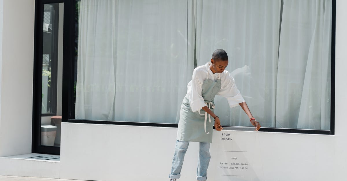 Should I be suspicious of meat/seafood on sale? - Diligent black female worker setting signboard outside cafeteria at sunny day