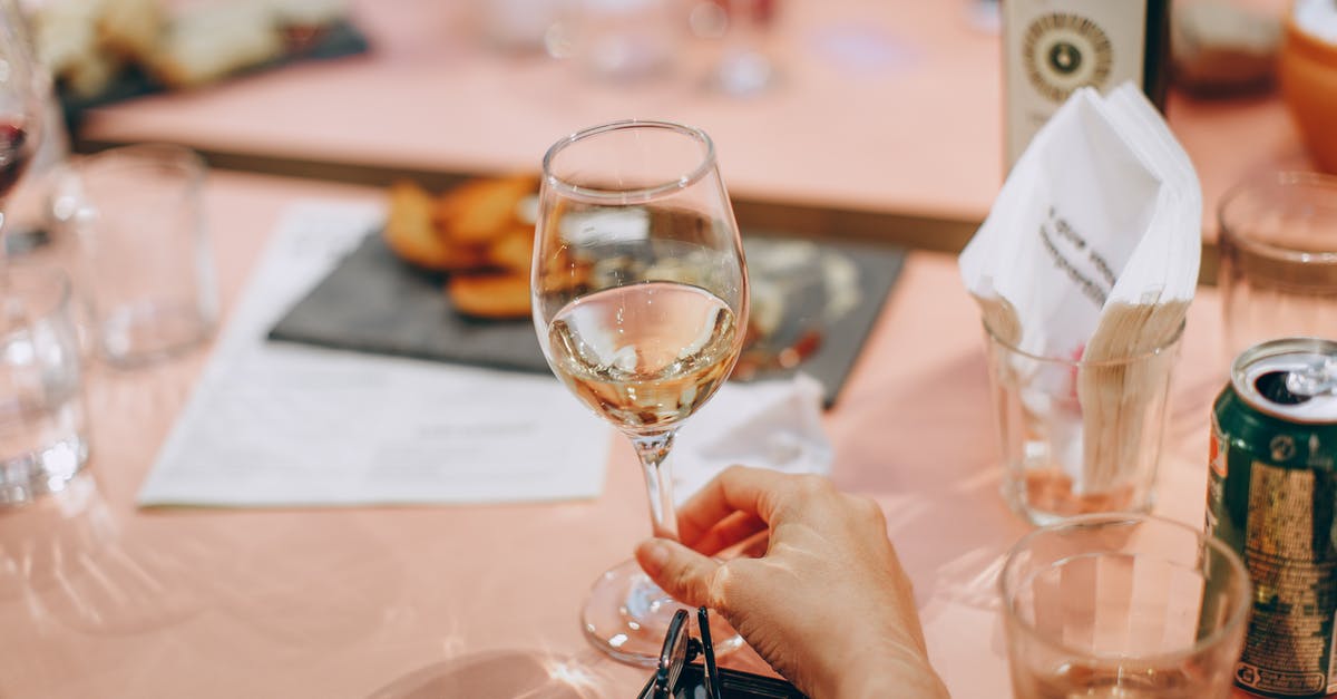 Should I boil the alcohol out of marinade? - Person Holding Wine Glass Near Clear Shot Glasses