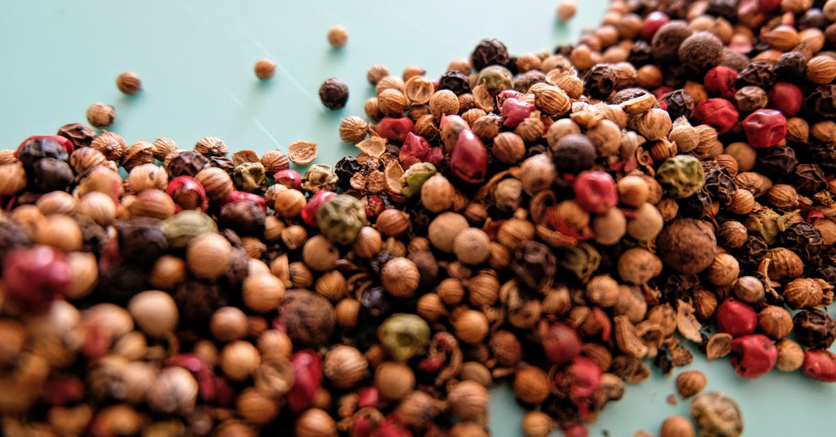 Should I crush the spice for Chai Tea Latte? - From above heap of assorted dried berries and herbs for traditional tea scattered on white table