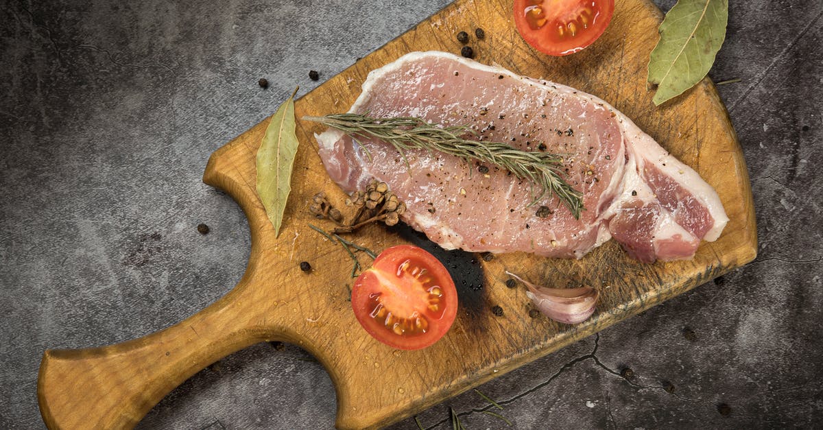 Should I marinate or dry-brine a steak first? - Sliced Tomatoes and Marinated Pork Meat on Brown Wooden Chopping Board