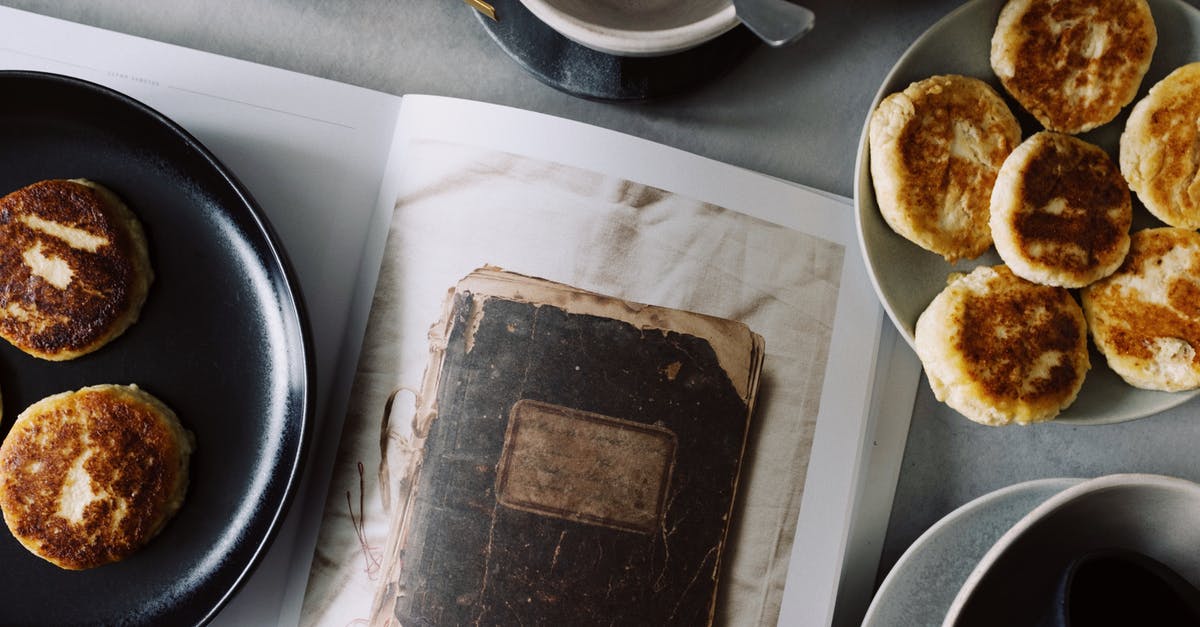 Should I read  ingredient weight as prepared or unprepared weight? - From above view of fresh hot buns served on plates near opened book on table with various kitchenware in light kitchen