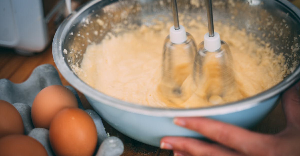 Should I reheat my eggs before using in recipe? - Person Using A Speed Handheld Mixer