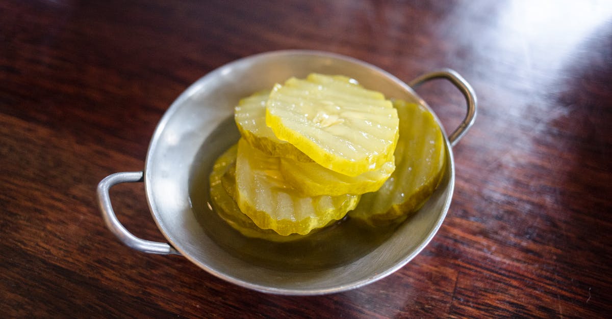 should my sour pickles be sealed while pickling? - Close-Up Photograph of Pickle Slices 