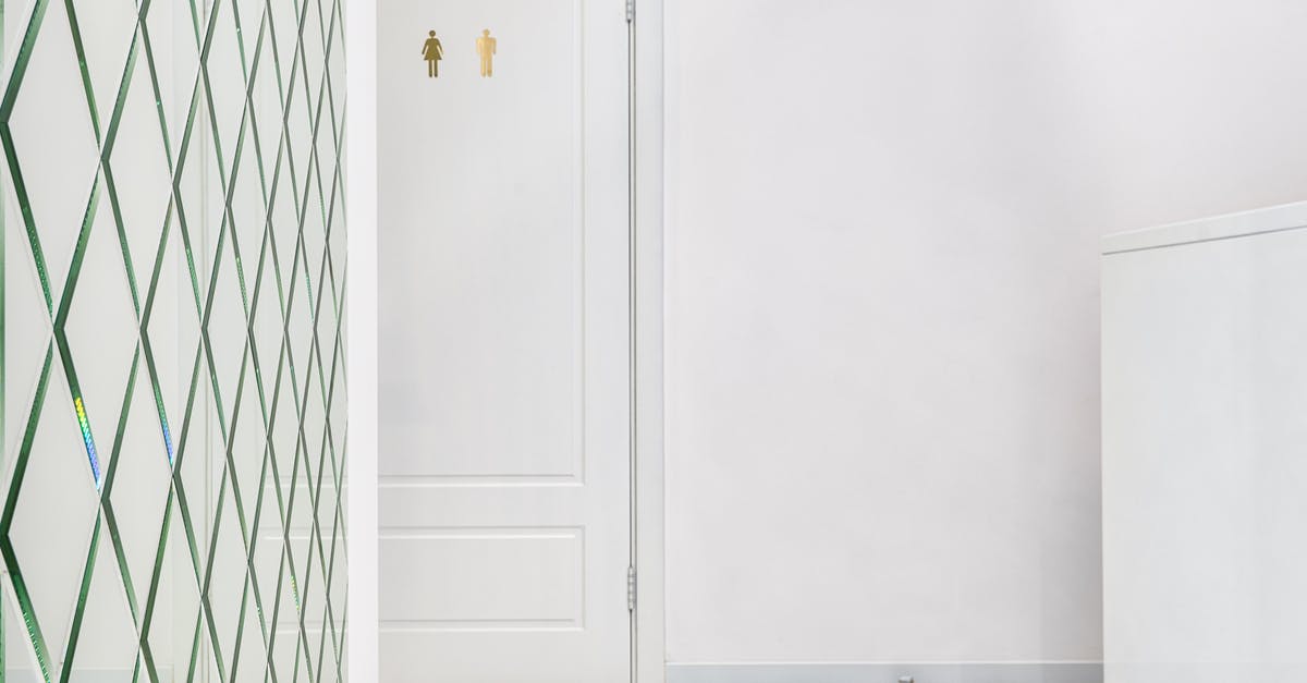 Simple way to pit plums - White room with closed door of restroom