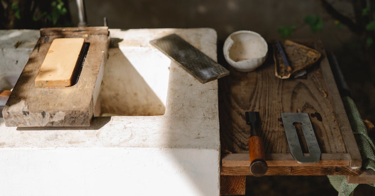 Size of holes for salt/pepper/seasoning shakers? - Assorted carpentry instruments on old washbasin outdoors