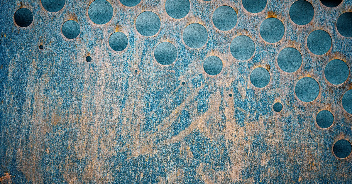 Size of holes for salt/pepper/seasoning shakers? - Textured backdrop of blue metallic wall with scratches and rusty round shaped holes