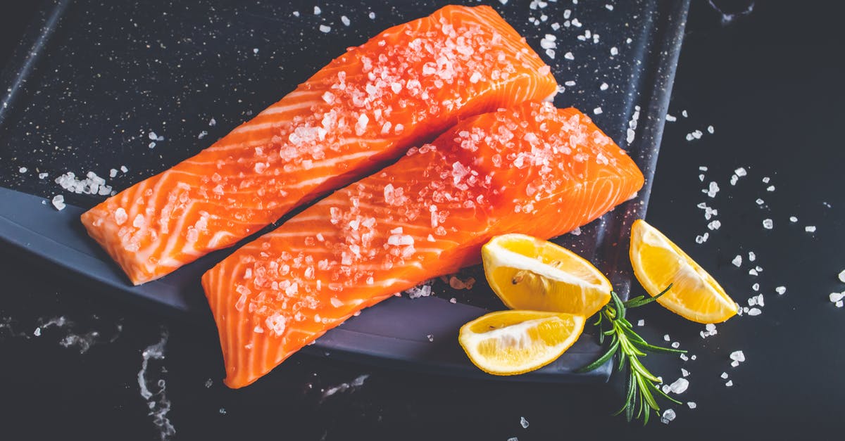 Size of pieces of fish for baking - Raw Pieces of Salmon with Salt and Lemon Wedges on a Baking Tray