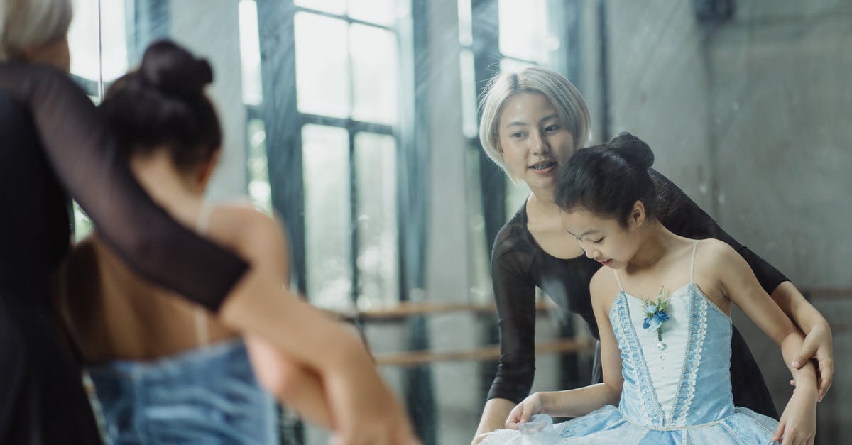 Skills that are only learned by professional chefs? - Professional ethnic ballerina teaching pupil ballet in dance room of school while looking at reflection in mirror