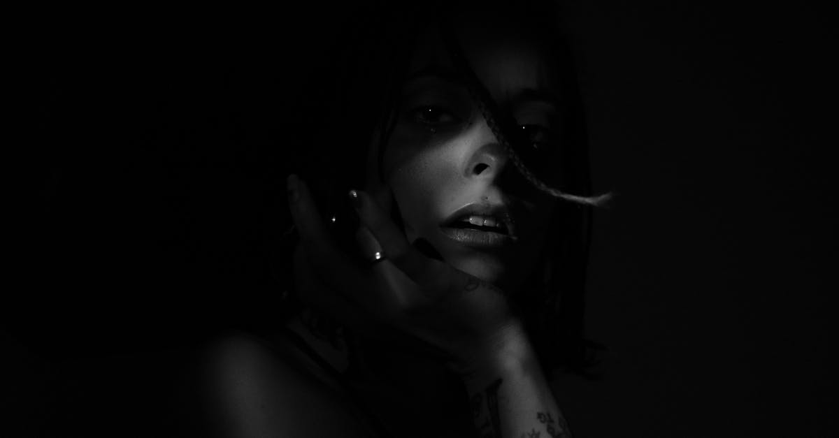 Skin on black bean soup - Unrecognizable woman with sensitive lips on black background at night