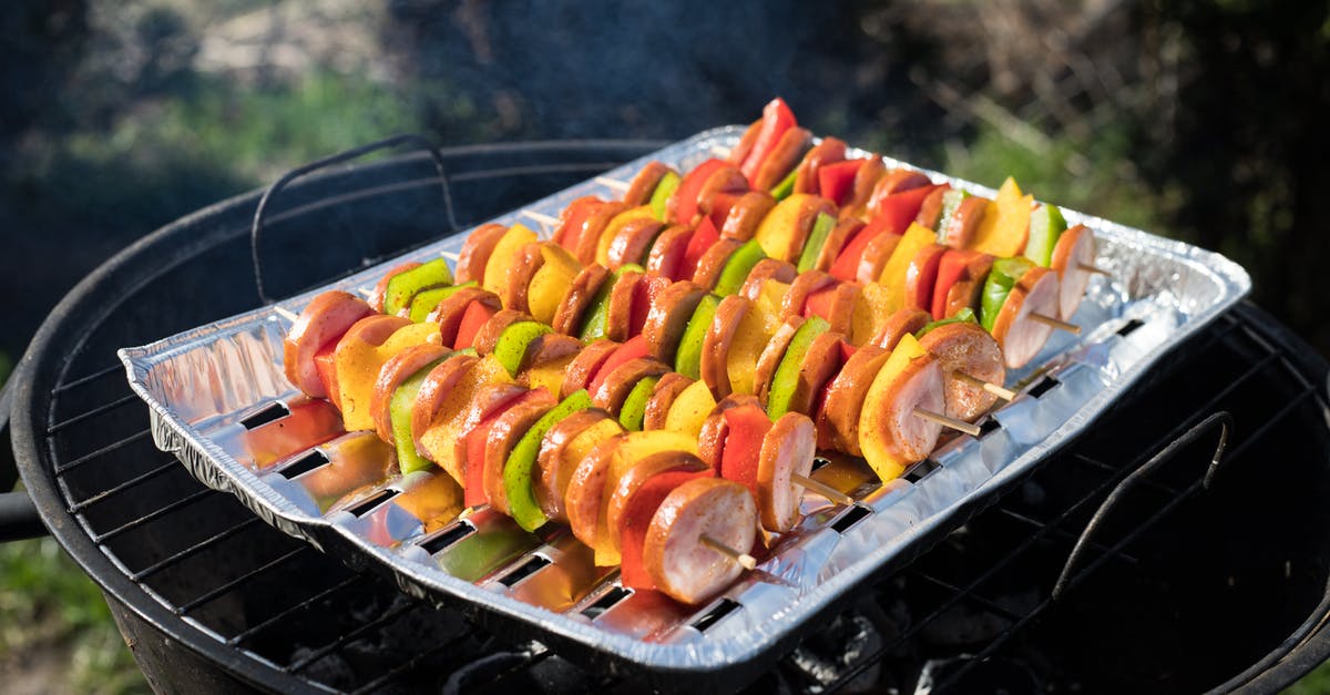 Slicing bratwurst for quicker, more even grilling - Slices of Sausages with Peppers Grilling