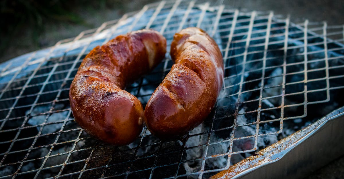 Slicing bratwurst for quicker, more even grilling - Two Sausages on Charcoal Grill