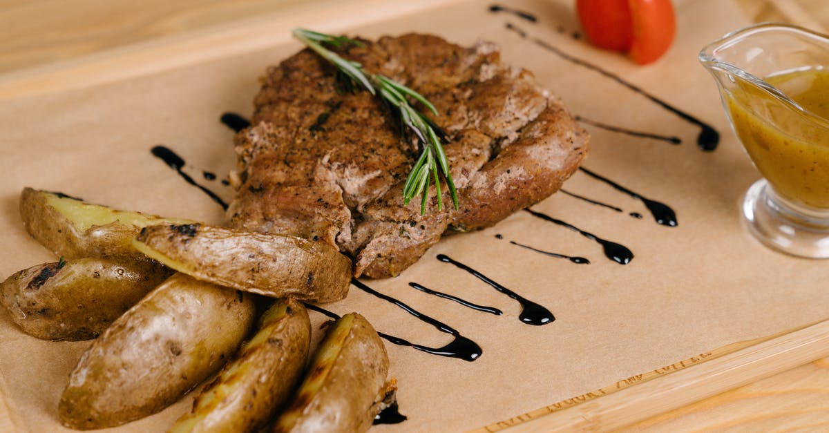 Slow roasting potatoes - Roasted Meat and Potatoes on Brown Wooden Board