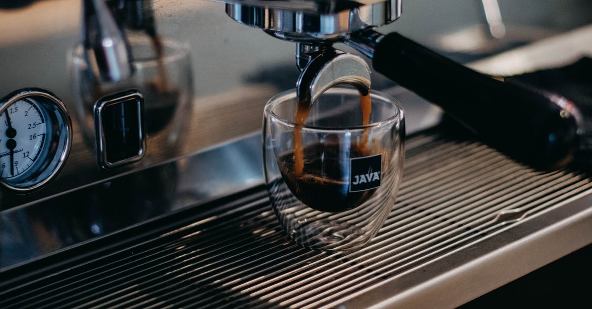 Small emulsified breakfast sausages in Dutch countries - Modern professional coffee machine pouring freshly brewed aromatic ristretto into small glass cup in coffee shop