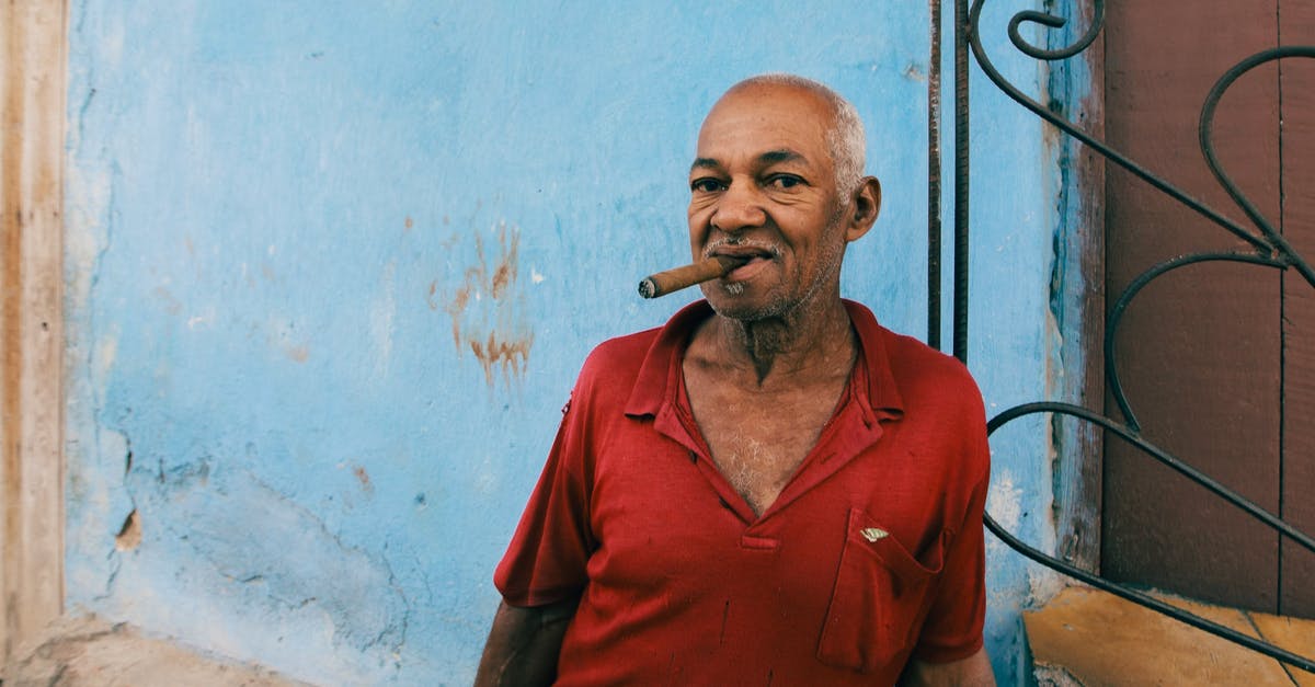 Smoker Ideas, something between Ribs and a Brisket - Man in Red Polo Shirt Smoking Cigarette