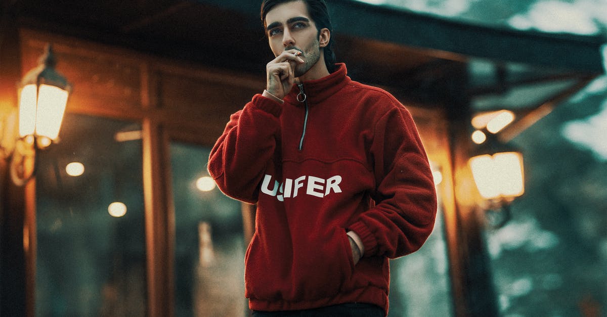 Smoker or Sous Vide first? - A Man in Red Sweater Smoking Cigarette