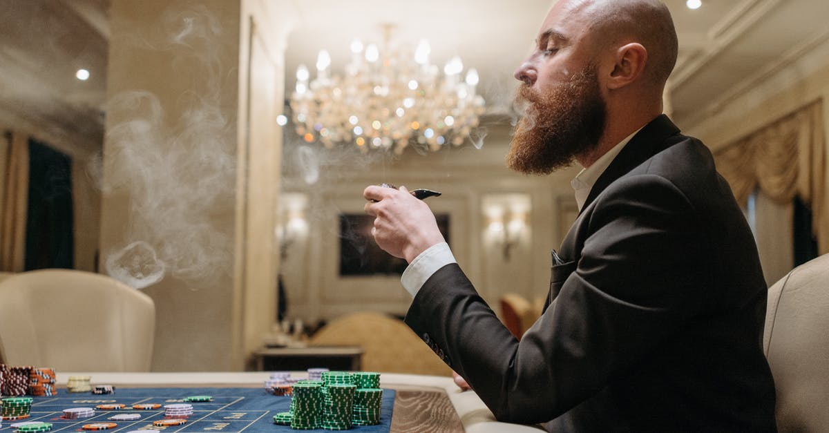 Smoking with chips after sous vide - Man in Black Suit Smoking Pipe While Playing on a Gaming Table