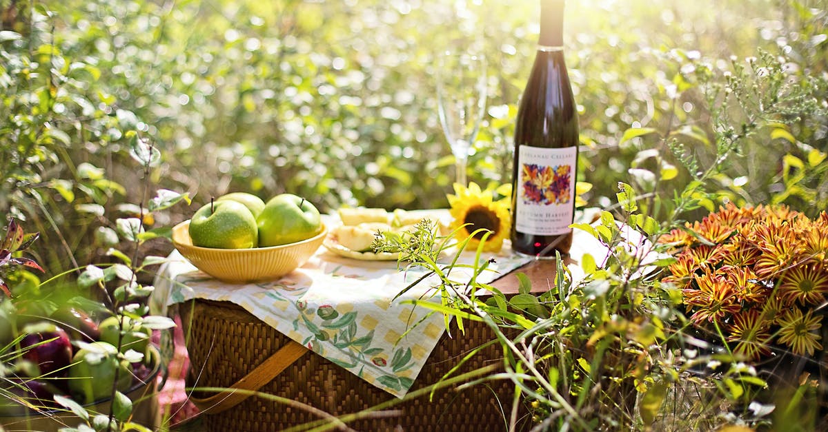 Soaking fruit in alcohol - Wine Bottle on Table With Fruits