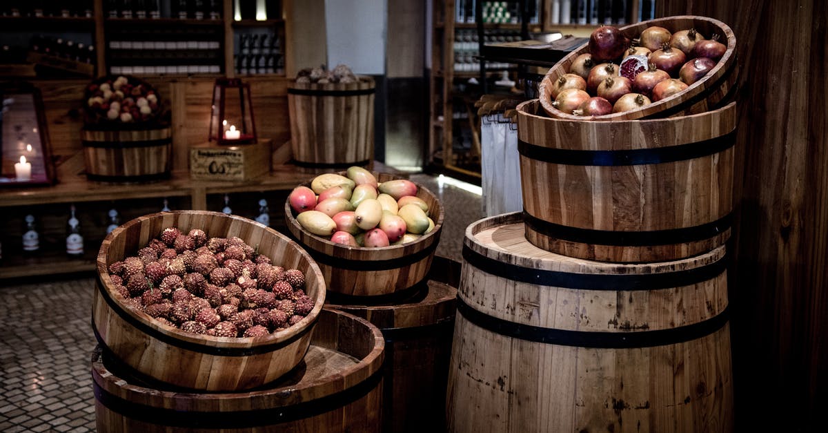 Soaking fruits and things in alcohol - Brown Wooden Barrels