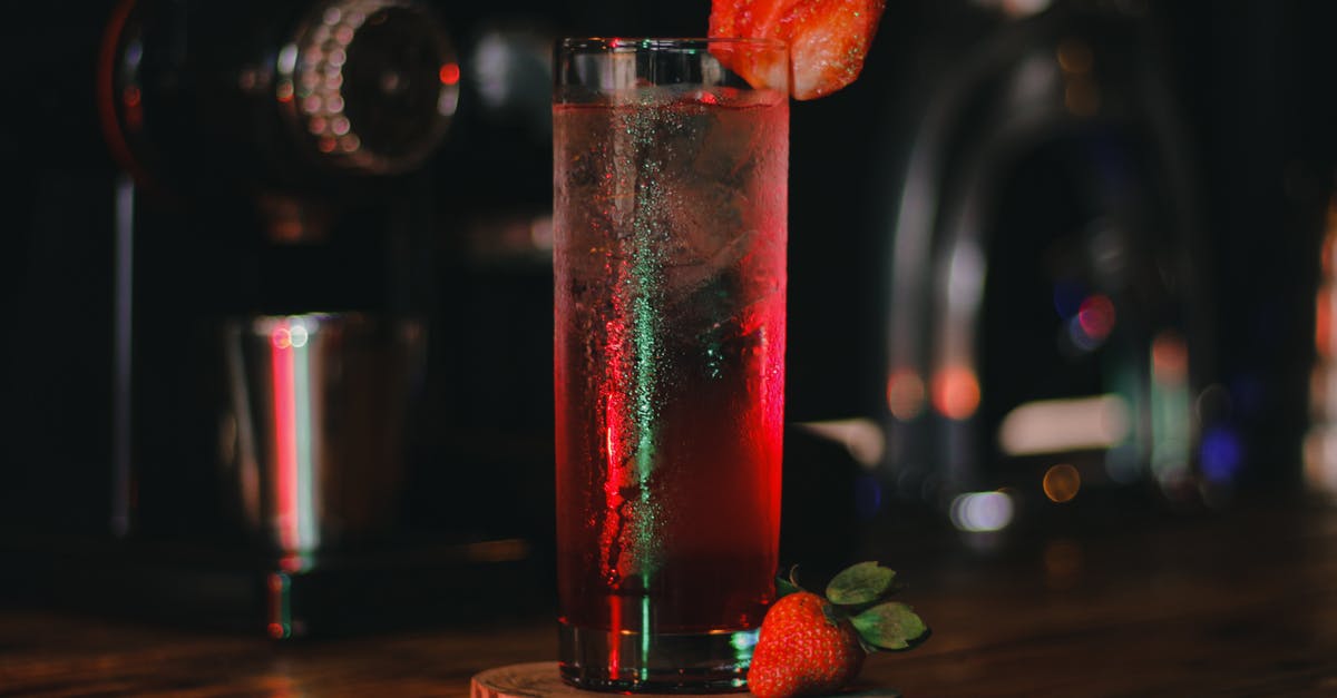 Soaking fruits in fruit juice [closed] - Clear Drinking Glass With Red Liquid on Brown Wooden Coaster