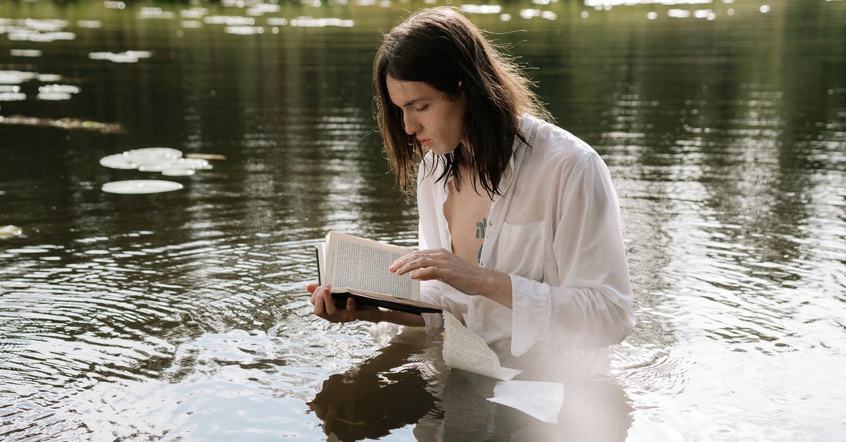 Soaking starches in water for better frying - A Tattooed Man in White Long Sleeves Soaking on the Lake while Reading a Book