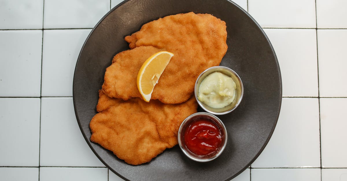 Some batter falls off during deep fry - Battered Fried Dish with Dips on a Black Plate