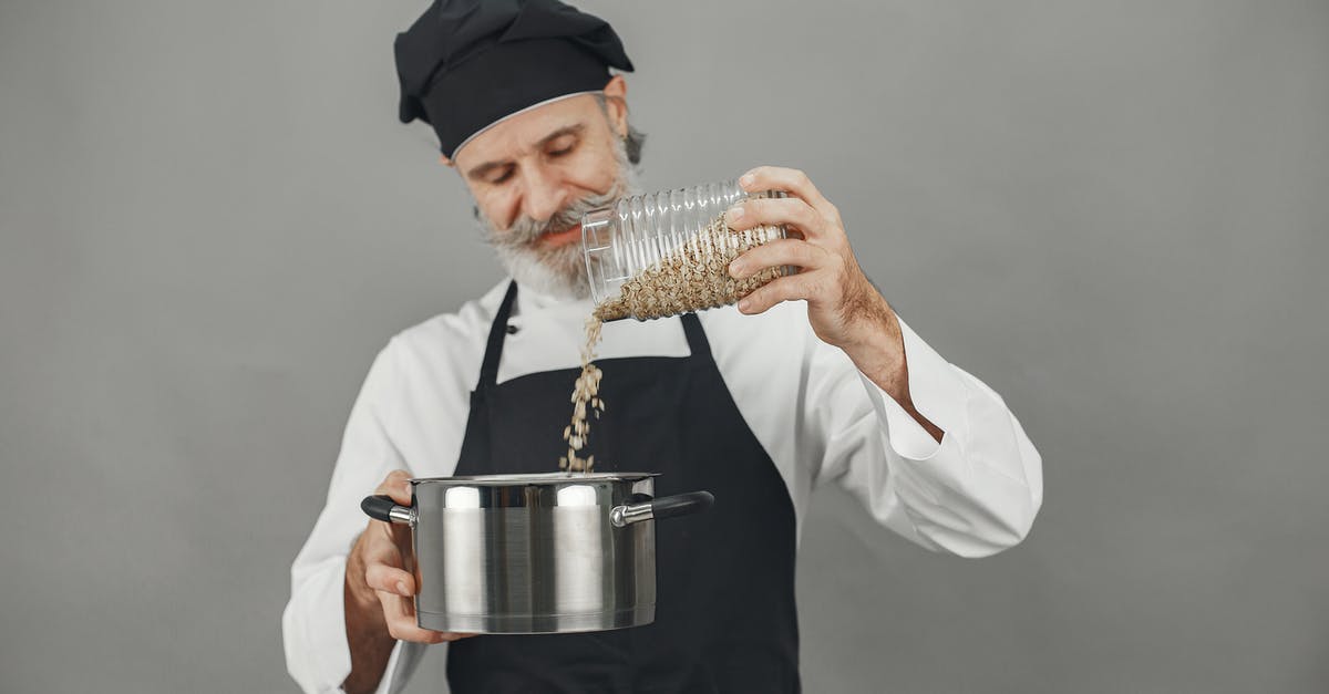 Something came out of oats. What's this? - Man in White Dress Shirt Holding Stainless Steel Cup