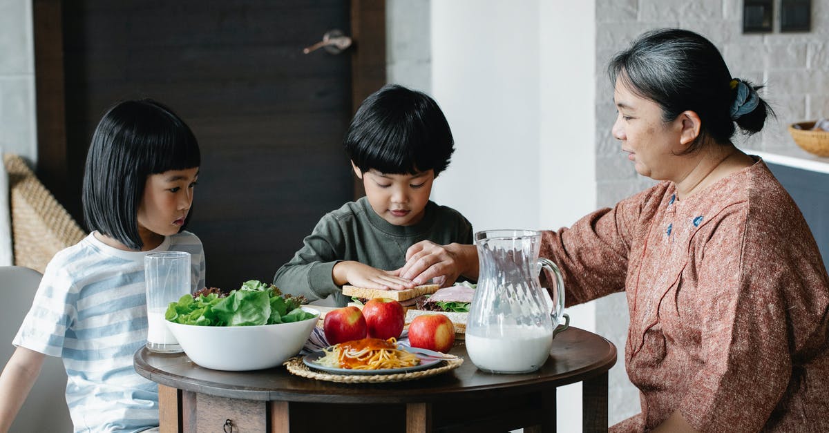 Soon-to-be cultured milk with fresh fruit safe for consumption? - Asian woman preparing healthy breakfast for children