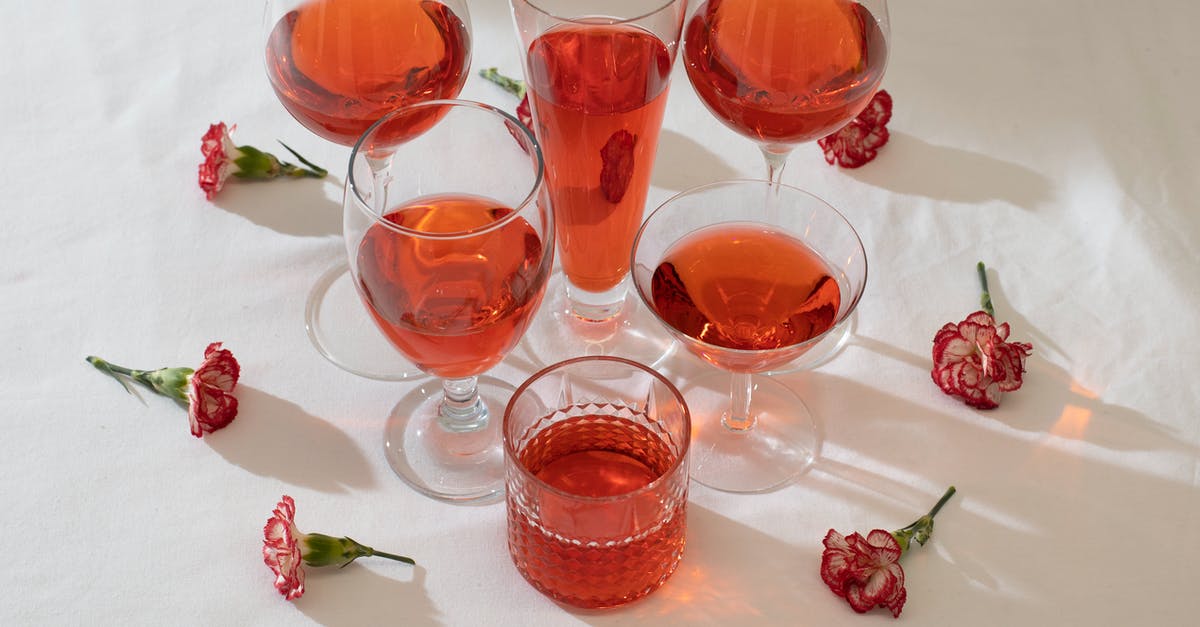 Soup has a floral taste - Arrangement of wineglasses with flowers on table