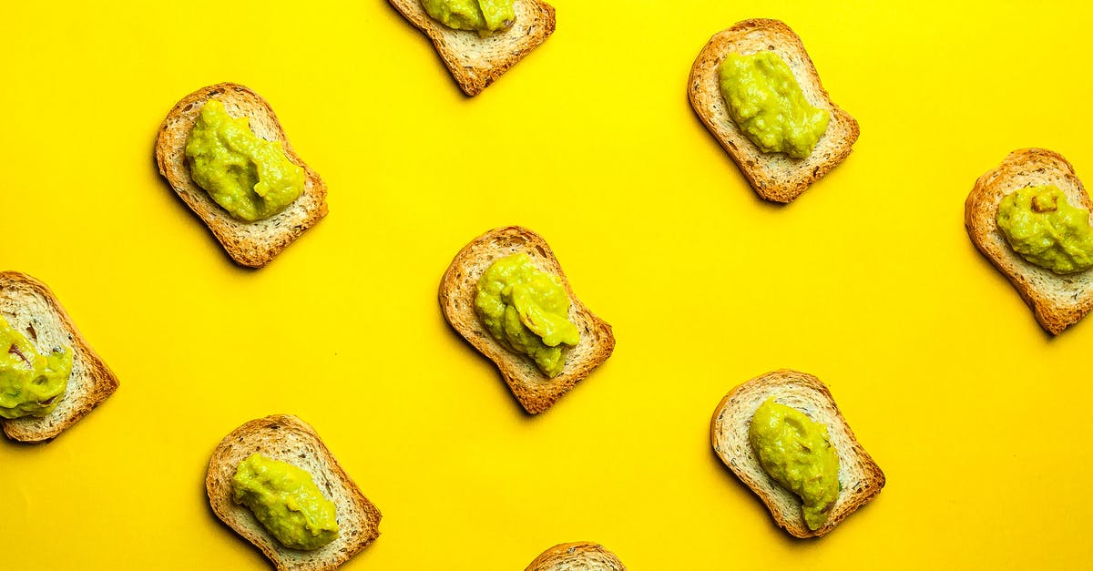 Sourdough Starter Crust forming - Top view composition of delicious toasts with delectable guacamole placed in rows on yellow background