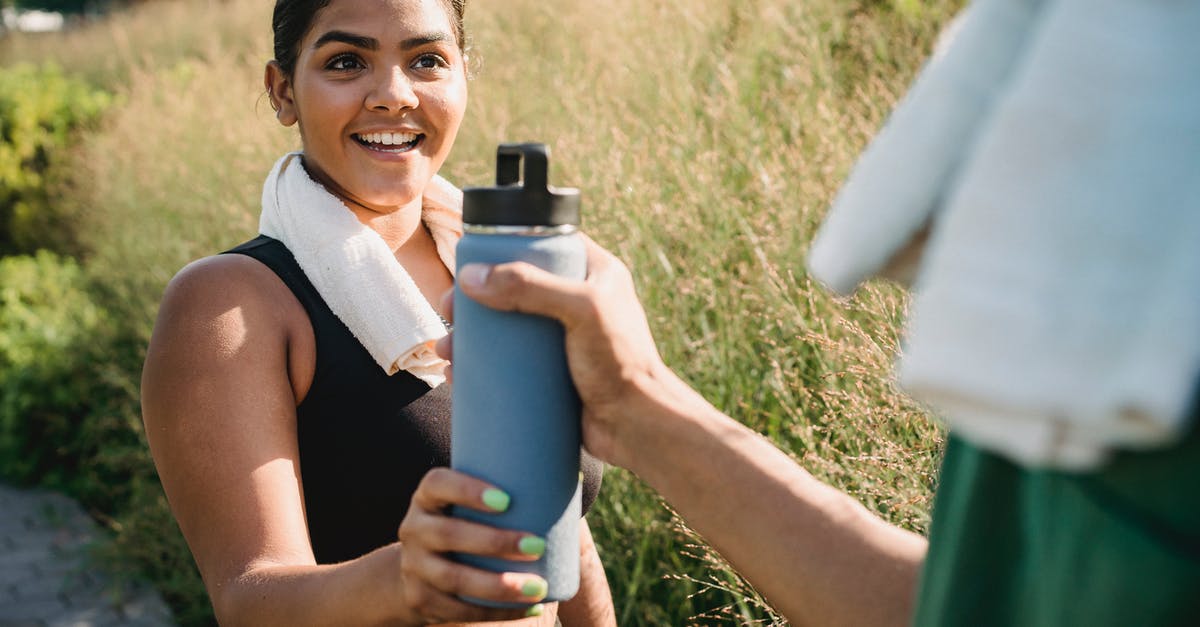 Sourdough starter hydration - Woman in Black Tank Top Holding Blue and Black Thermal Carafe