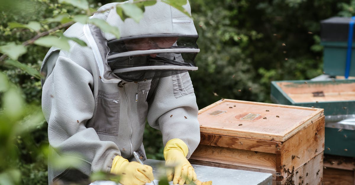 Sous Vide danger zone for vegetables - Unrecognizable farmer taking notes in apiary